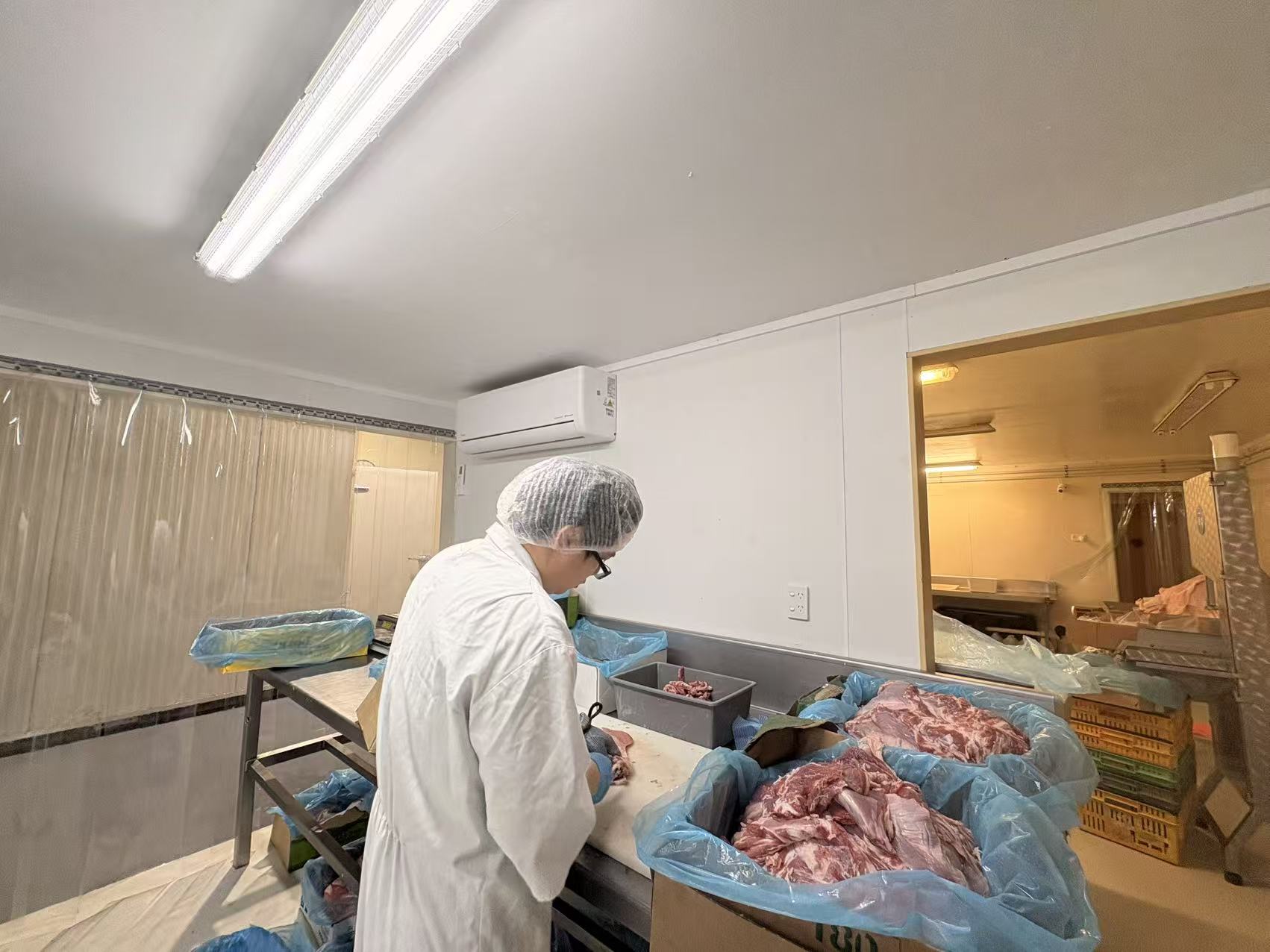 Sun Foods team member preparing meat in the Auckland processing room